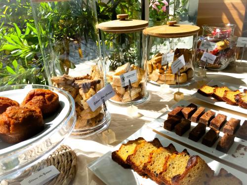 a table with many different types of cakes and pastries at Hôtel Sampiero in Propriano