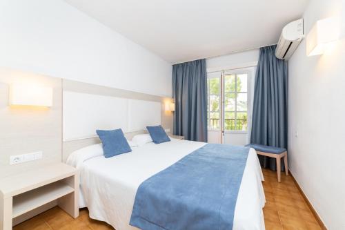 Ένα ή περισσότερα κρεβάτια σε δωμάτιο στο Apartamentos Casa Vida