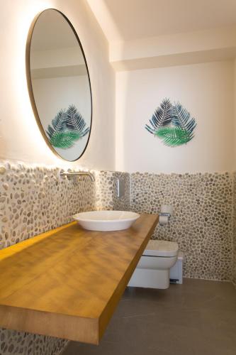 a bathroom with a sink and a mirror at Apartamentos Costamar II in Es Pujols