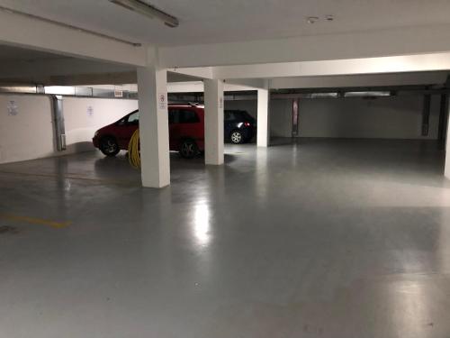 a parking garage with two cars parked in it at Apartments Bane in Herceg-Novi