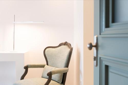 a chair sitting in front of a door at Hotel Senia - Onar Hotels Collection in Naousa
