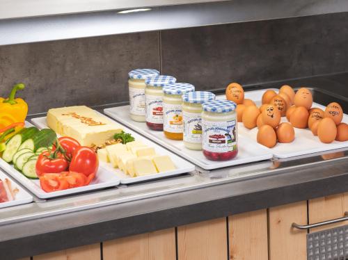 a buffet with two trays of cheese and other foods at JUFA Hotel Maria Lankowitz in Maria Lankowitz