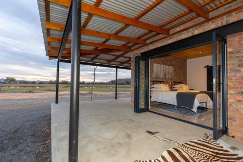 a room with a bed in a brick building at Kransplaas - Nyala Lodge in Graaff-Reinet