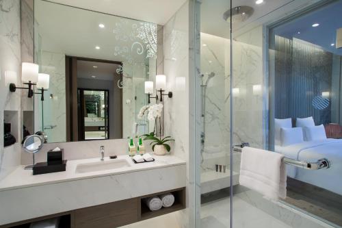 a bathroom with a sink and a shower at Pullman Ciawi Vimala Hills Resort in Bogor