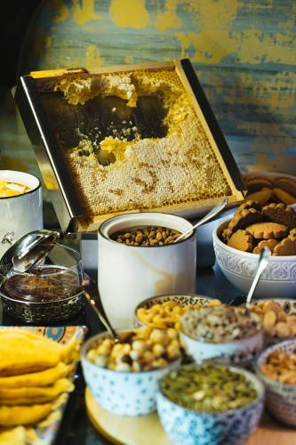 a table with different types of food in bowls at The First One Madrid Preciados in Madrid