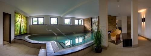 a swimming pool in a house with a pool at Walpurgishof in Hahnenklee-Bockswiese