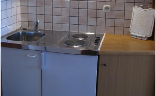 a small kitchen with a stove and a sink at Apartments Miho in Orebić