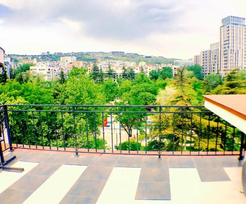a balcony with a view of a city at Villa Garden in Tbilisi City