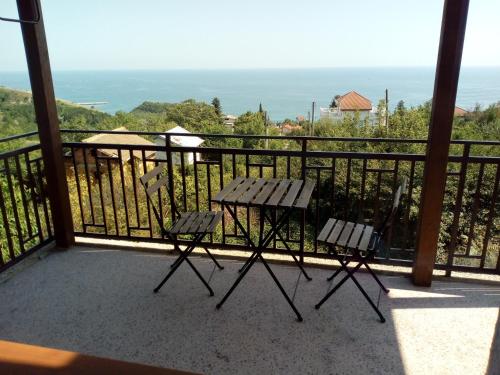 a balcony with two chairs and a table at Casa Del Grey in Balchik