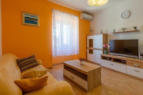 a living room with a couch and a television at House Lara in Vela Luka