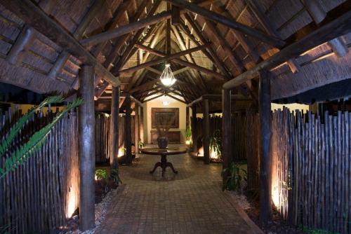 a room with a table in the middle of a building at Premier Resort Mpongo Private Game Reserve in Macleantown