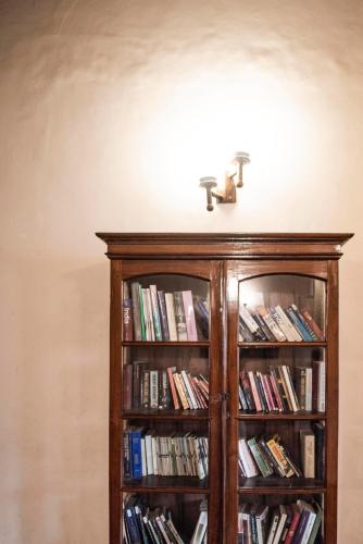 a book shelf filled with books with a faucet at Dutch Bungalow in Cochin