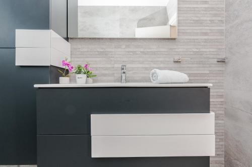 a bathroom with a black and white sink at Villas A & N in Zaton