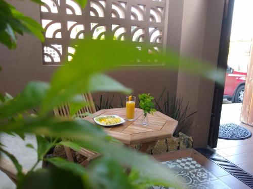 a small table with a plate of food and a candle at Casa 5 Bed & Breakfast in Palenque