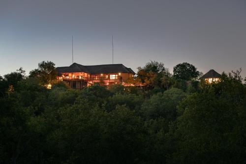 a house on a hill with lights on at Parsons House in Hoedspruit
