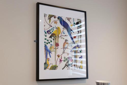 a framed picture of birds on a wall at Blackbird Luxury Apartments Room 1 in Blackpool