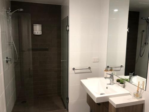 a bathroom with a sink and a shower at Central Escape @ Adelaide CBD in Adelaide