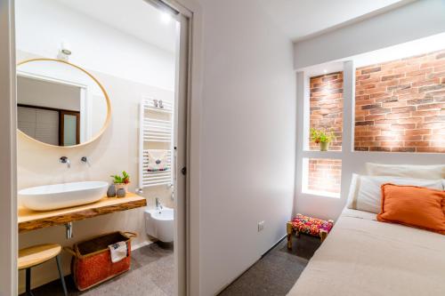 a bathroom with a bed and a sink and a mirror at B&B Villa Maria Pia in Monopoli