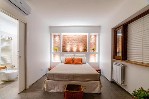 a bedroom with a bed and a bathroom with a sink at B&B Villa Maria Pia in Monopoli