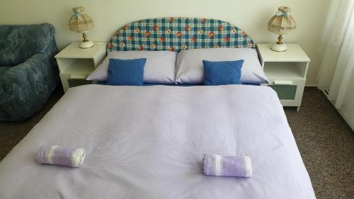 a bedroom with a large bed with two pillows on it at Konvalinka - ubytování v soukromí in Harrachov