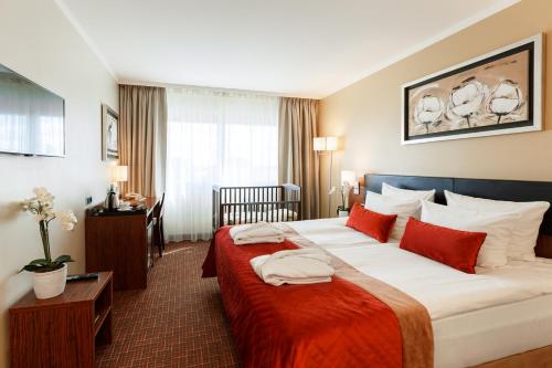 Postel nebo postele na pokoji v ubytování Avalon Hotel & Conferences
