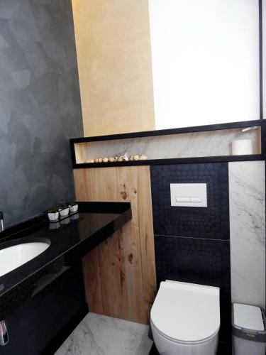 a bathroom with a white toilet and a sink at Panoramic View in Odesa