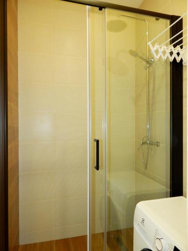 a shower with a glass door in a bathroom at Panoramic View in Odesa