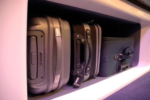 a drawer full of suitcases sitting on a shelf at YOTELAIR London Gatwick Airport in Horley