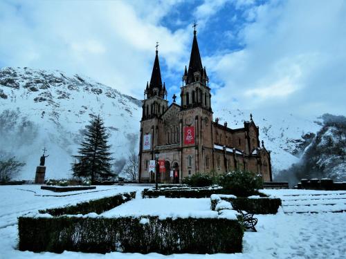 an old building with snow on the ground at Hotel Cerro La Nina in Beceña
