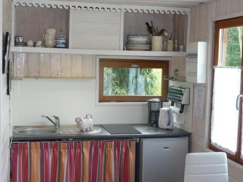 a kitchen with a sink and a counter top at Les Bruyères du Mont in Céaux