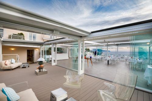 a house with a balcony with a view of the ocean at Villa Fiorella Art Hotel in Massa Lubrense