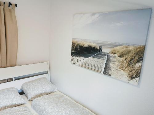 a bedroom with a picture of a beach at Sankt-Nikolaus Old Town City Apartment in Innsbruck