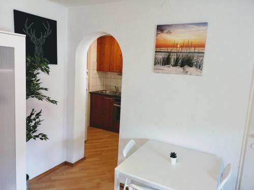 a kitchen with a white table in a room at Sankt-Nikolaus Old Town City Apartment in Innsbruck