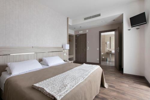 Giường trong phòng chung tại Hotel Conradi