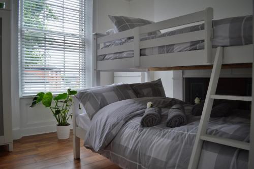 a bedroom with a white bunk bed with a ladder at Apartment 4 Hamilton Square in Birkenhead
