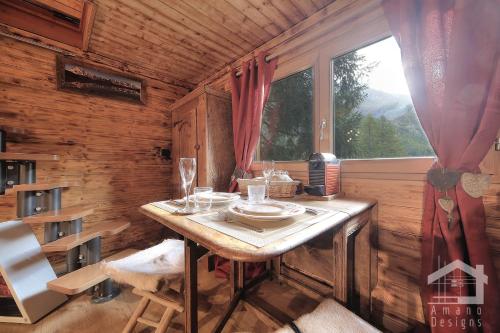 a small table in a room with a window at Le Mazot de la Fis in Chamonix-Mont-Blanc