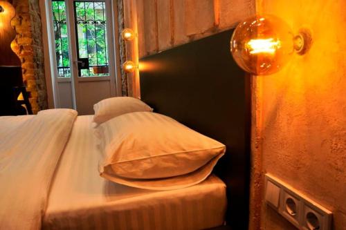 a bedroom with a bed with pillows and a window at Kyiv Volcano Studio in Kyiv