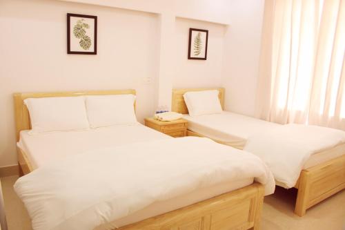 Postel nebo postele na pokoji v ubytování Daisy Dalat House