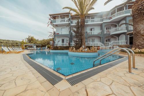a swimming pool in front of a hotel at Zante Calinica Hotel in Tsilivi