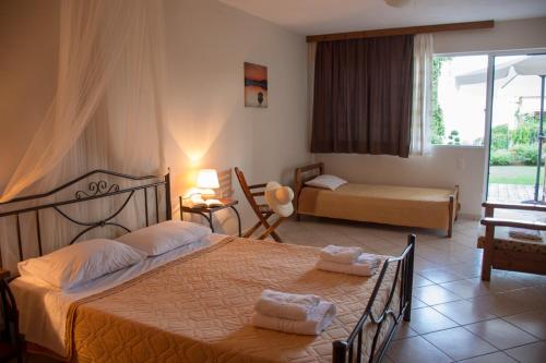 a hotel room with a bed and a window at Christianna Studios in Nikiana