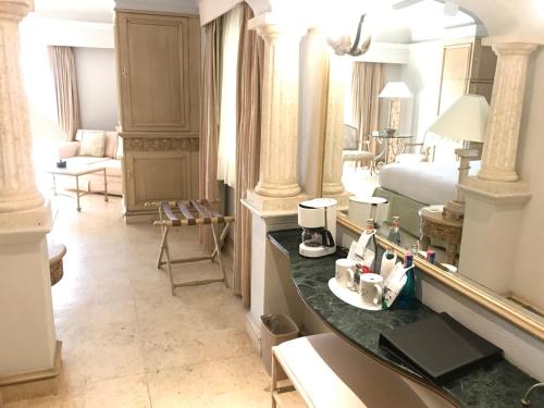 a large room with a bed and a table with cosmetics at Grand Isla Navidad Golf & Spa Resort with Marina in Barra de Navidad