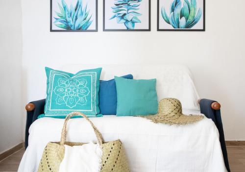 a bedroom with a bed with blue and green pillows at L'Incanto Divino Di fronte solo l'orizzonte! in Riomaggiore