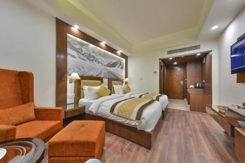 a hotel room with a bed and a couch at Regenta Central Srinagar, Rajbagh in Srinagar