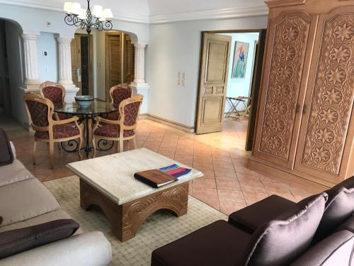 a living room with a couch and a table at Grand Isla Navidad Golf & Spa Resort with Marina in Barra de Navidad