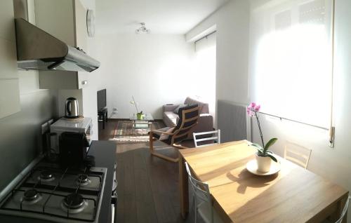 a kitchen with a stove and a wooden table at B&B Stadio Apartment in Pordenone