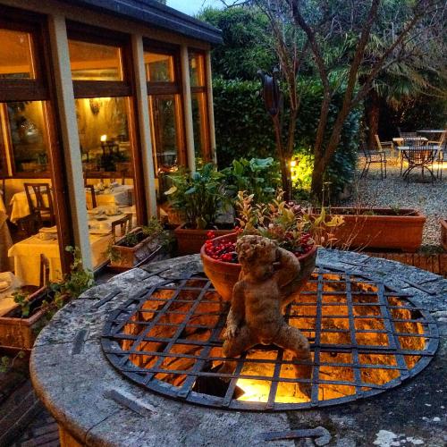 a teddy bear sitting on top of a table at Hotel Santa Caterina in Siena