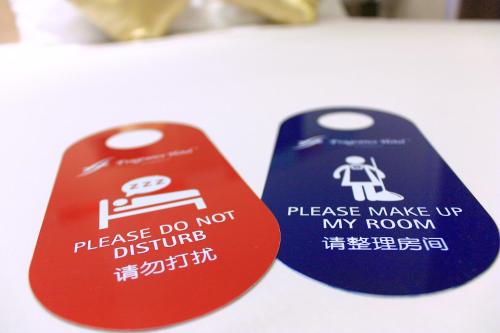 two signs that say please do not disturb at Fragrance Hotel - Classic in Singapore