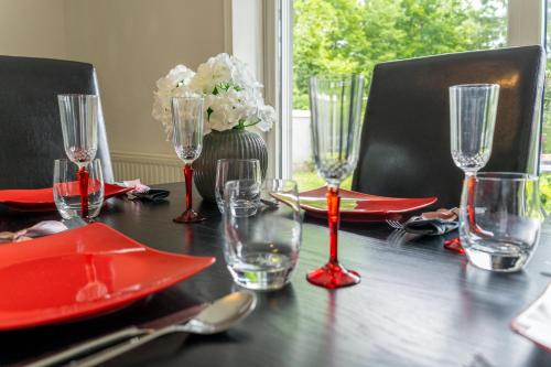 a black table with red plates and glasses on it at Sweet Secret in Samobor