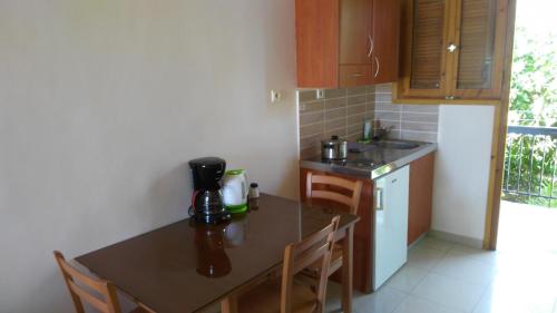 a kitchen with a table with a coffee maker on it at Villa Christina in Tolo