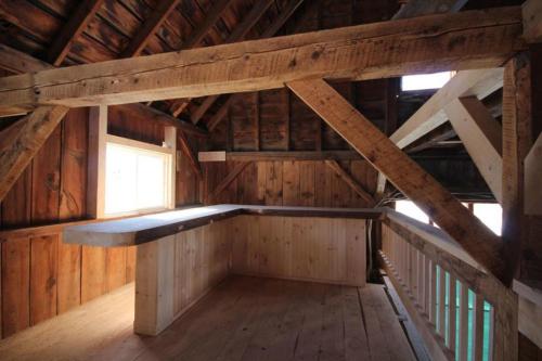 an empty room in a wooden cabin with a window at Highland Lake Inn in Andover